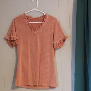 Ruffle neckline and short sleeve hem on peach blouse